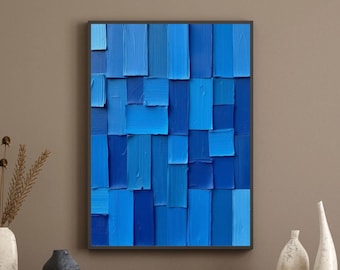 Puede incluir: Una pieza de arte mural rectangular que presenta una disposición vertical de trazos de pintura gruesos y texturizados en varios tonos de azul, desde el azul cielo claro hasta el azul marino profundo, creando un patrón de bloques.