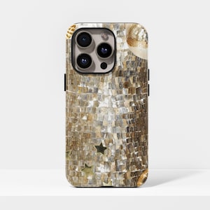 May include: A phone case with a mosaic design in shades of gold and brown. The case features a black camera module and gold star accents. The overall design has a disco ball aesthetic.