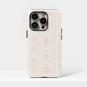 May include: A phone case with a floral design. The case features a pattern of pink roses and vertical stripes on a cream background. The phone case has a black camera lens and black side buttons.
