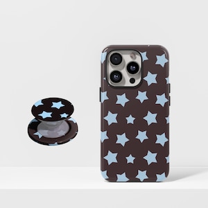 May include: A brown phone case and a matching phone grip featuring a repeating pattern of light blue stars. The phone case is designed to fit a smartphone, and the grip is a circular, collapsible stand.