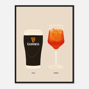 May include: A framed print showing two drinks: a pint of Guinness stout and an orange cocktail. The Guinness is labelled "HIS", the cocktail "HERS". The print has a cream background and a black frame.