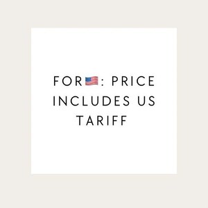 以下が含まれることがあります： 「FOR: PRICE INCLUDES US TARIFF」と書かれた黒い文字と小さなアメリカ国旗のグラフィックが描かれた白い正方形。