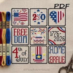 May include: A cross-stitch pattern featuring nine squares with patriotic designs. The squares include an American flag, a heart, the words "Freedom" and "Home of the Brave", and the date "1776-2026". The color palette is red, white, and blue.