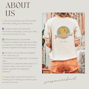 May include: A beige t-shirt with a circular graphic on the back featuring a yellow shirt and flower, with the text "Yes You CanFind" and "EST. 2025." The shirt is paired with orange shorts.