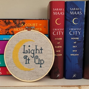 Crescent City inspired Light It Up completed cross stitch.