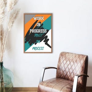 May include: A motivational poster with a black, white, orange, and teal color scheme. The poster features the text "Work in Progress, Trust the Process".