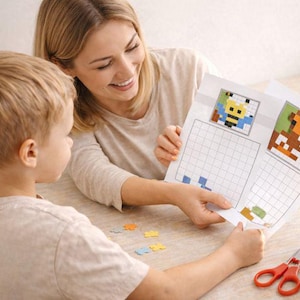 May include: A woman and a child are seated at a table, looking at a paper with pixel art designs of a bee and a horse. Colored pencils, scissors, and puzzle pieces are on the table. The scene suggests a craft or educational activity.