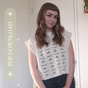 May include: Cream-colored crochet top with a floral pattern and a high neckline. The top has short sleeves and a slightly flared hem. The text "PDF DOWNLOAD" is printed vertically on the left side of the image.