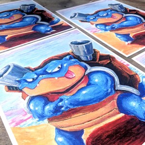 May include: Artwork featuring a blue cartoon turtle-like creature with a brown shell and two cannons. The artwork is hand-drawn with blue, brown, red, and orange hues. Several prints are visible, showcasing the same character in a dynamic pose.