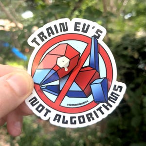 May include: A sticker with a red, blue, and white geometric design of a creature, crossed out with a red circle. Text reads "TRAIN EU'S" and "NOT ALGORITHMS" in a white font.