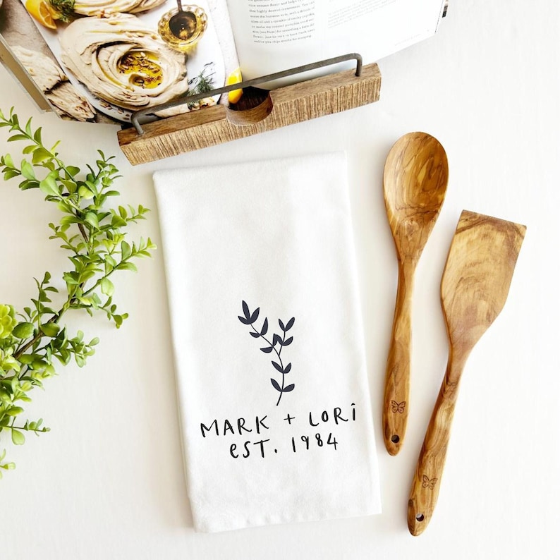Personalized Tea Towel Wedding Gift Custom Name Date Flour Sack Kitchen Linen Newlywed Couple Keepsake Cotton Dish Towel Bride Groom Present Housewarming Gift Farmhouse Decor Black Lettering White Background Machine Washable Home Essential