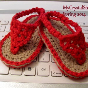 May include: A pair of red and beige crocheted flip-flops. The flip-flops are on a white laptop keyboard. The text "MyCrystalStrands Spring 2014" is visible in the upper right corner of the image.