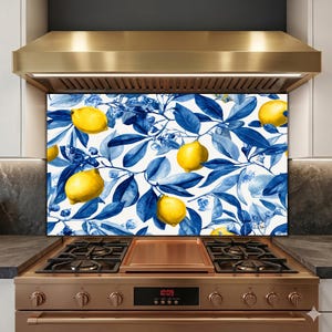 May include: A kitchen splashback with a lemon and foliage design. The pattern features bright yellow lemons and deep blue leaves against a white backdrop. The design is a repeating pattern of lemons and leaves.