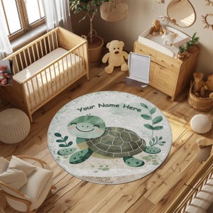 May include: A circular children's rug with a cartoon turtle design. The turtle has a green and brown shell and a smiling face. The rug has a light beige background with the text "Your Name Here". The rug is surrounded by green leaves.