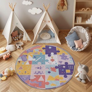 May include: A colorful round puzzle-piece rug in a child's playroom. The rug features a variety of shapes and colors, including purple, yellow, and blue. Two small teepee tents and a basket with pillows are also in the room.