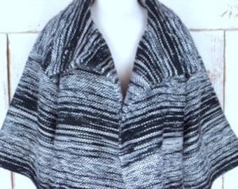 May include: A black and white striped open-front cardigan with a long, flowing silhouette.