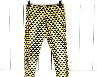 Metallic gold black harlequin triangle stretch knit leggings