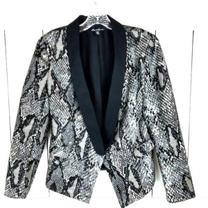 May include: A black and white snakeskin patterned blazer with a black satin collar and a pointed hem.