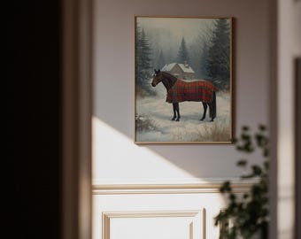 May include: A framed painting depicts a brown horse wearing a red and black plaid blanket, standing in a snowy landscape. The background features a house, trees, and a foggy atmosphere, creating a winter scene.