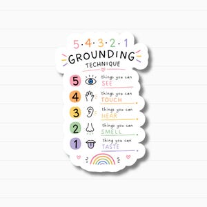 May include: A white sticker featuring the text "5-4-3-2-1 GROUNDING TECHNIQUE" in a colorful design. It lists the five senses: see, touch, hear, smell, and taste, each with an icon. A rainbow and hearts are at the bottom of the sticker.