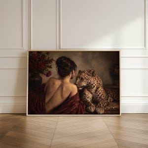 Leopard print showing a back-turned woman wrapped in burgundy fabric beside a reclining leopard in a dimly lit vintage interior.
