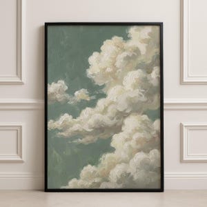 May include: A framed art print of a cloudscape. The artwork shows fluffy, white clouds set against a muted green backdrop. The clouds are painted with soft brushstrokes, creating a dreamy effect. The frame is black.