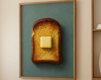 May include: A framed artwork showing a slice of toast with a pat of butter. The toast is golden brown with darker edges, set against a teal background. The artwork is in a wooden frame.