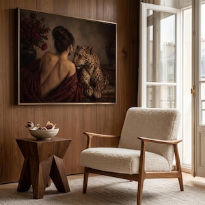 Leopard print showing a back-turned woman wrapped in burgundy fabric beside a reclining leopard in a dimly lit vintage interior.