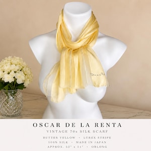 May include: Butter yellow vintage Oscar de la Renta silk scarf with lurex stripes. The oblong scarf, made in Japan, is approximately 52 inches long and 11 inches wide. The scarf is draped on a white mannequin.