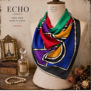 May include: A vintage silk scarf with a vibrant geometric design in red, blue, green, yellow, and purple. The scarf is labeled "ECHO" and "100% Silk Made in Japan". The scarf is draped on a mannequin.