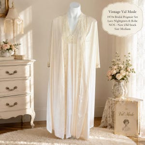 May include: A vintage cream-coloured bridal peignoir set from the 1970s, including a lace nightgown and robe. The set is new old stock and size medium. The image includes the text "Vintage Val Mode".