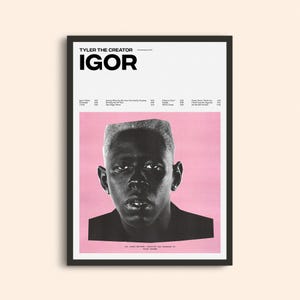 May include: A framed poster for Tyler, The Creator's "IGOR" album. The poster has a pink background with a black and white portrait of the artist. The album title is in bold black letters at the top, with a tracklist.