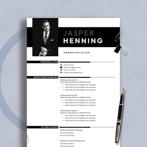May include: A monochrome resume template featuring the name "JASPER HENNING" and the job title "MARKETINGLEITER". The document includes sections for personal details, work history, and education. A black pen and paper clips are on the surface.