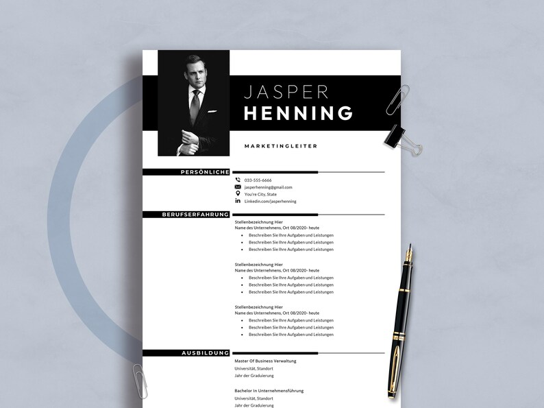 May include: A monochrome resume template featuring the name "JASPER HENNING" and the job title "MARKETINGLEITER". The document includes sections for personal details, work history, and education. A black pen and paper clips are on the surface.