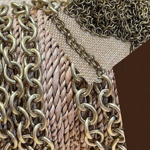 May include: A close-up of a gold chain with a rope-like texture. The chain is coiled and appears to be made of metal. The text "By Pluffbeads" is visible in the top left corner of the image.
