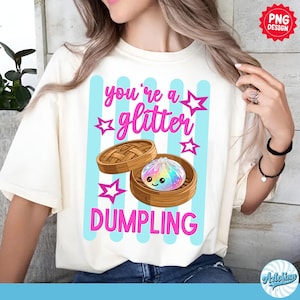 May include: Cream-colored t-shirt with a graphic of a dumpling in a bamboo steamer. The text "you're a glitter DUMPLING" is in pink, with blue vertical stripes and star accents. The design is a PNG.