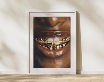 May include: A framed art print featuring a close-up of a smiling mouth with gold teeth. The artwork showcases a person's lips and teeth, with the gold teeth sparkling against the dark skin tone. The print is in a white frame.