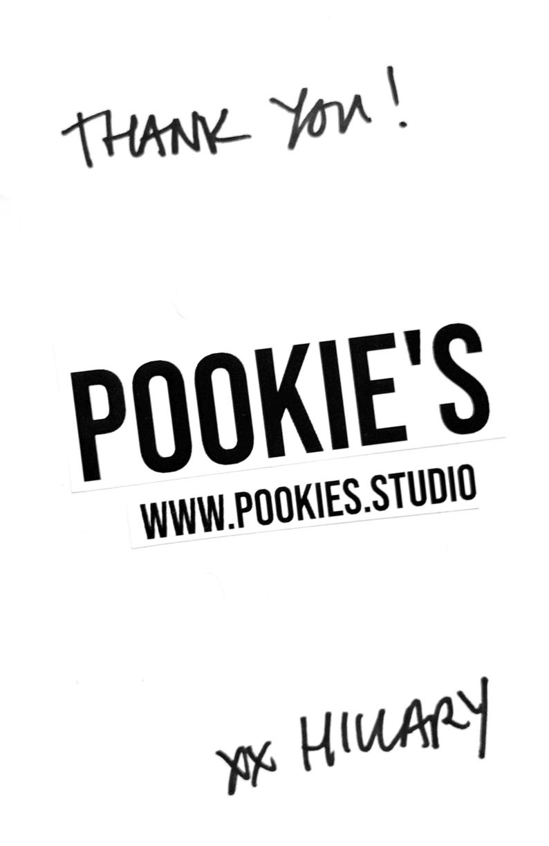 May include: A white background with handwritten text that says "THANK YOU!" in black ink. Below is a black and white logo that says "POOKIE'S" and "WWW.POOKIES.STUDIO". At the bottom is the signature "xx HILARY".
