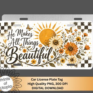 May include: A rectangular metal car license plate featuring a white background with a black and white checkered border. The design includes a yellow sun, orange sunflowers, butterflies, and the black script text, He Makes All Things Beautiful.