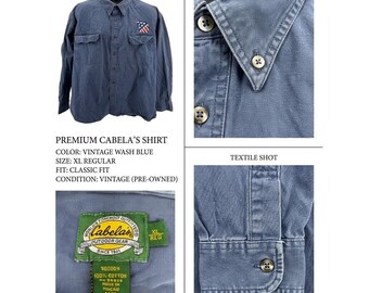 Camisa vintage Cabela's XL azul de algodón con botones, calavera de águila y bandera estadounidense.