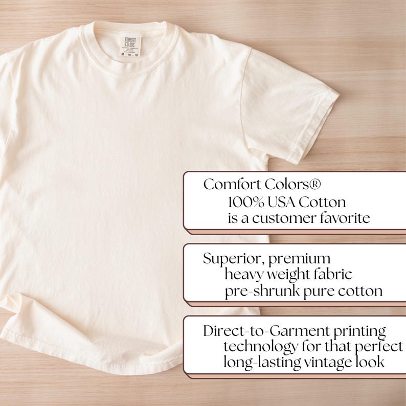 May include: Cream-colored t-shirt made of 100% USA cotton. The shirt features a crew neck and short sleeves. Text on the image states it is a customer favorite, with superior, premium, heavy weight fabric, and direct-to-garment printing technology.