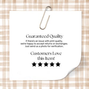 May include: A white paper note with the text "Guaranteed Quality" and "Customers Love this Item!" is held by a silver paper clip. The note has five black stars and is set against a beige plaid background.
