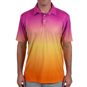 May include: A short-sleeved polo shirt with a vibrant gradient design. The shirt transitions from a deep pink at the top to a bright orange at the bottom. It features a collared neckline and a three-button placket.