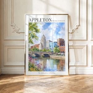May include: A framed watercolor print of the Appleton, Wisconsin skyline featuring a stone bridge over a river, lush green trees, and colorful flowers in the foreground. The text APPLETON WISCONSIN appears at the top and The midwestern collection at the bottom.