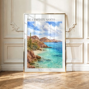 May include: A framed vertical wall art print featuring a watercolor landscape of Isla Espíritu Santo, Mexico. The scene depicts rocky brown cliffs, a tall green cactus, turquoise water, and a blue sky with white clouds. Text reads: ISLA ESPÍRITU SANTO MEXICO.