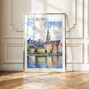 May include: A framed watercolor print of the Aalborg, Denmark waterfront featuring a tall church spire, colorful buildings, and a small boat on the water. The text AALBORG DENMARK appears at the top and The travel collection is at the bottom.