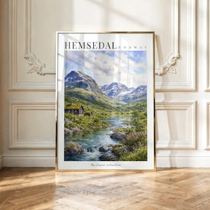 May include: A vertical wall art print featuring a landscape painting of Hemsedal, Norway. The image displays snow-capped mountains, a flowing river, and a small cabin. The text reads HEMSEDAL NORWAY at the top and The Travel collection at the bottom.