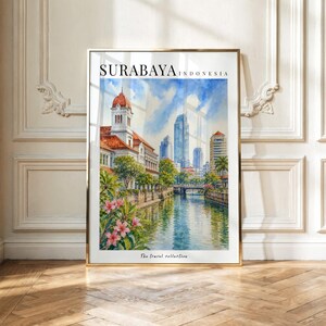 May include: A vertical art print featuring a watercolor painting of a cityscape in Surabaya, Indonesia. The scene depicts a canal with a historic building on the left, modern skyscrapers in the distance, and pink flowers in the foreground.