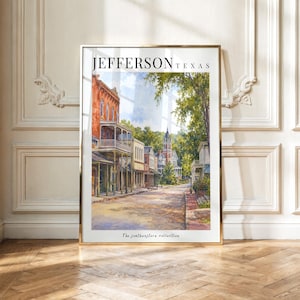 May include: A framed vertical art print titled JEFFERSON TEXAS featuring a watercolor-style street scene with historic brick buildings, a prominent tower, and lush green trees. The text The southwestern collection appears at the bottom.