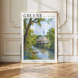 May include: A framed art print titled GRUENE TEXAS featuring a landscape painting of a river flowing past a house on stilts and a water tower, surrounded by green trees and blue sky, with the text The southwestern collection at the bottom.